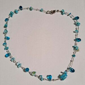light and dark blue different shaped beaded necklace with metal clasp